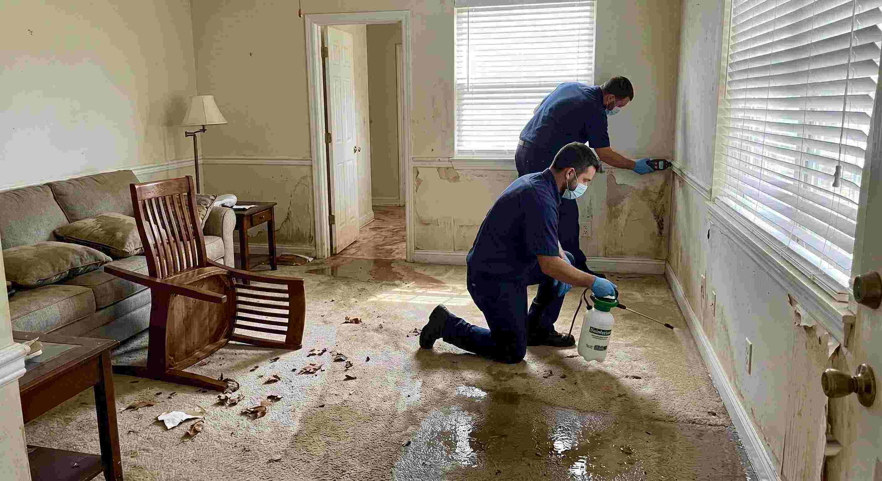 Expert technicians performing flood disinfection after water damage inside a home in Miramar, ensuring wet floors, damp walls, and household items are sanitized safely.