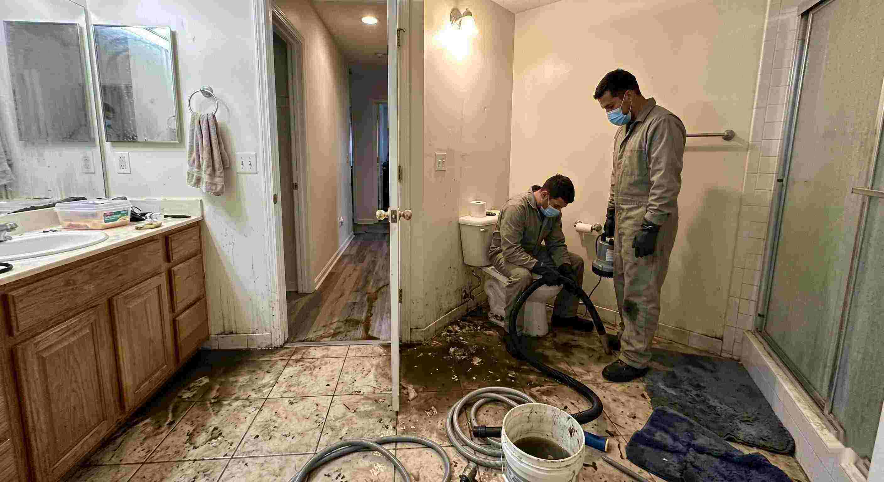 Fast septic tank backup cleanup in Boca Raton bathroom with technicians removing contaminated water and sanitizing affected areas